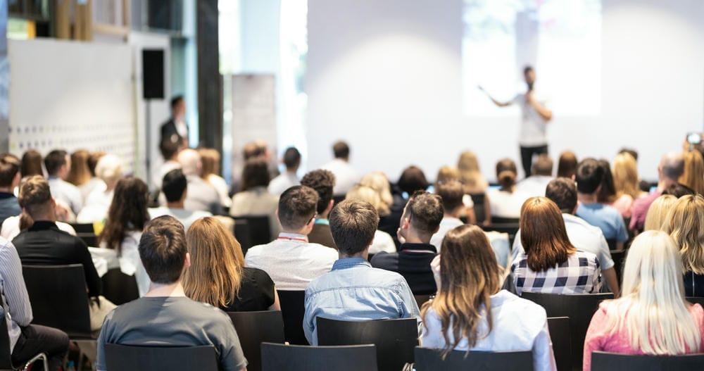 People listening to a talk at an exhibition centre