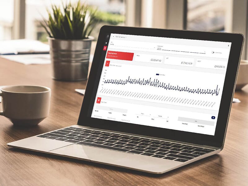 Laptop on desk showing management Portal dashboard